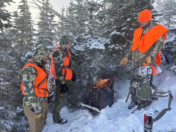 Hunters gathered in the snowy timber