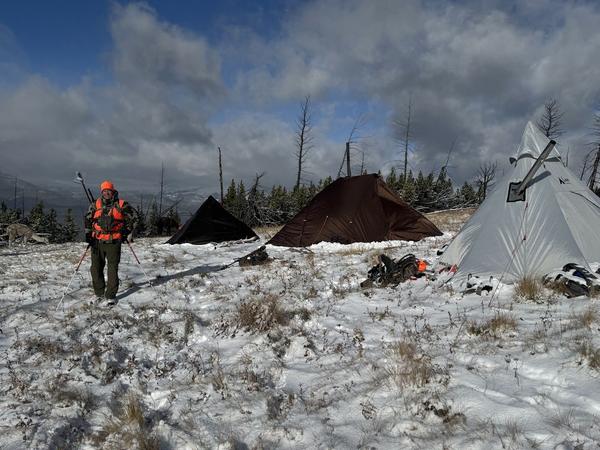 Wall-tent hunting camp in the snow